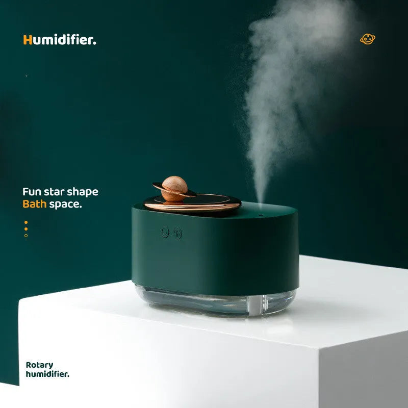 Green rotating planet-shaped USB humidifier with night light on a desk.