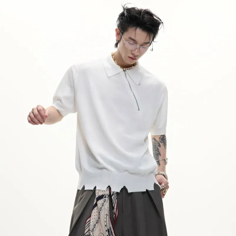 Man modelling a slim-fit black knitted polo shirt with an oblique diagonal zip closure and short sleeves.