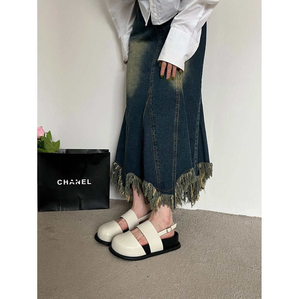 Retro women's sandals with a closed toe, ankle strap buckle, and platform sole in apricot colour.