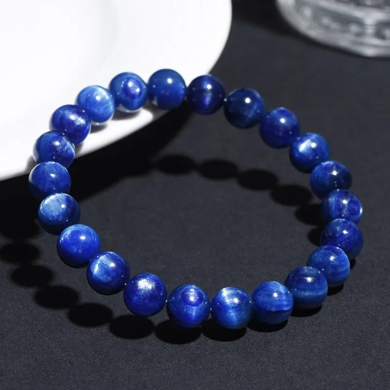 Polished blue crystal bracelet with geometric shapes and ruyi design elements on wrist