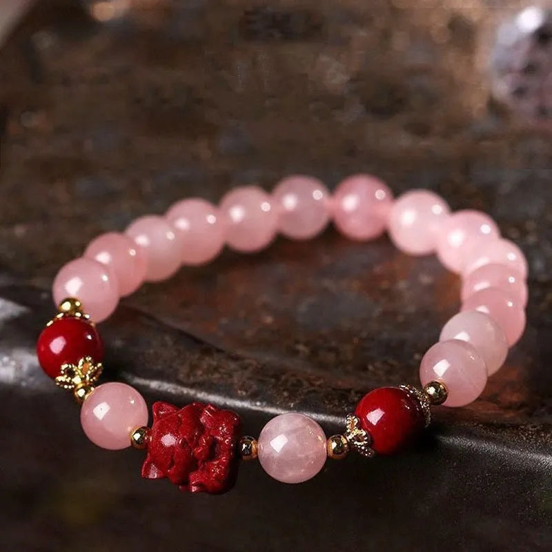 Women's aquamarine crystal bracelet with round geometric beads in mixed materials including natural pink crystal and imitation pearl