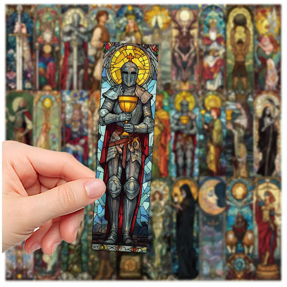 Set of 30 painted glass tarot bookmarks with cute artwork on paper, laid out flat.