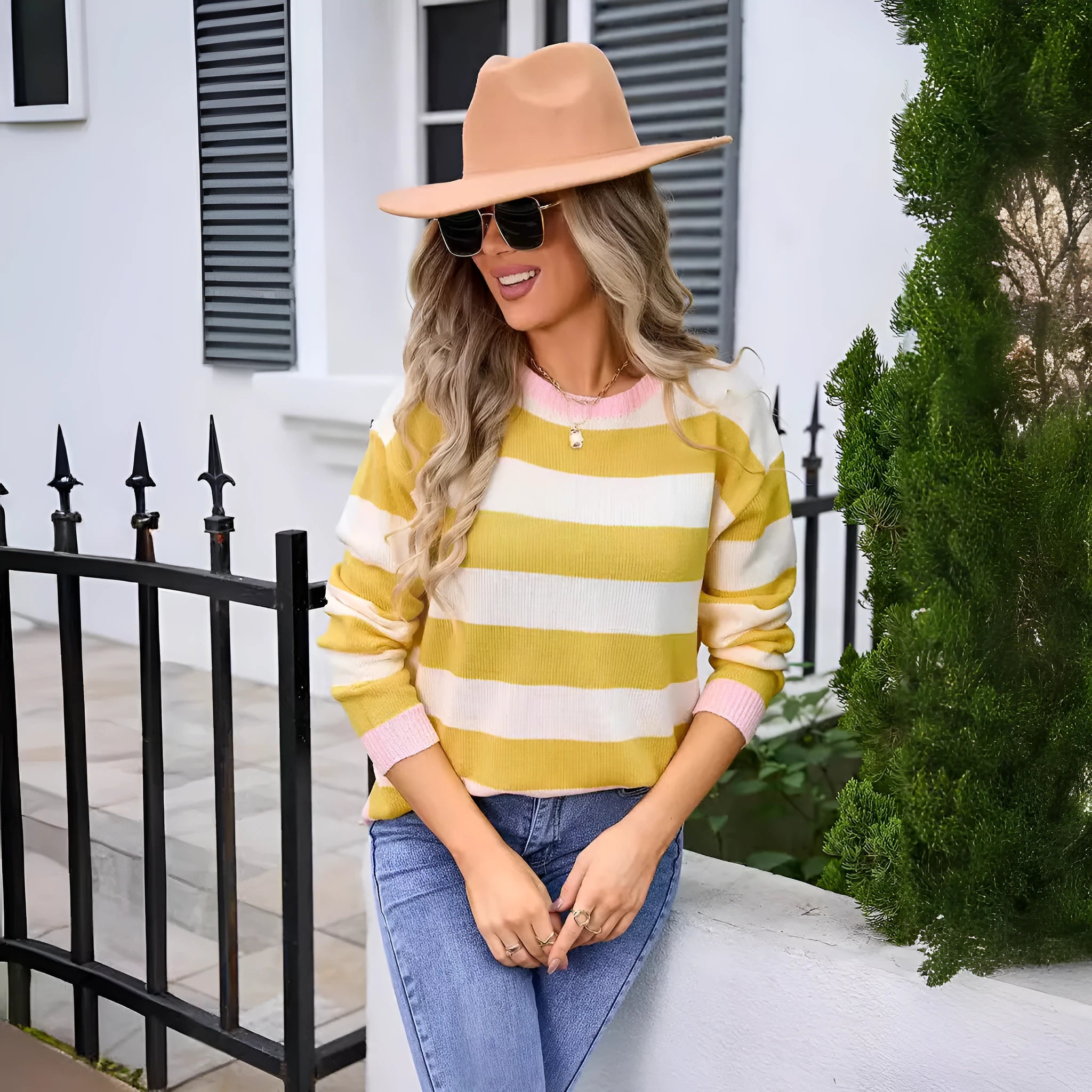 Women's loose blue striped acrylic long sleeve round neck sweater on a hanger