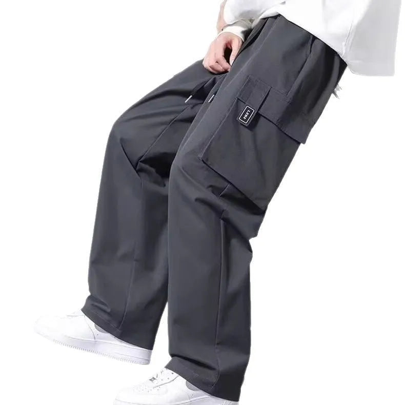 Boys straight cargo pants in army green with large side pockets and drawstring waist on white background