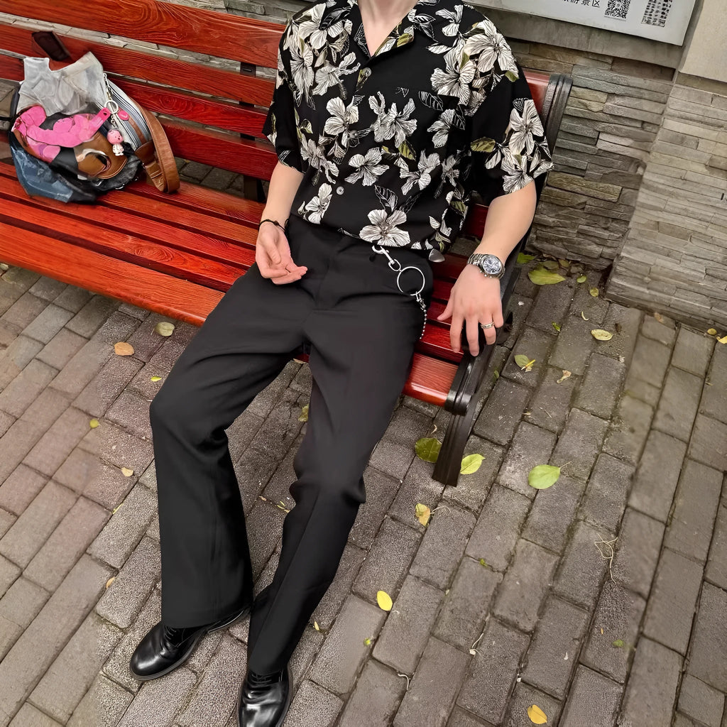 Men's black floral print ice silk Cuban collar short sleeve shirt laid flat.