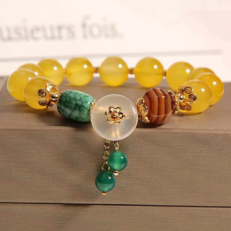 Yellow agate crystal bracelet with gold silk threading on wrist