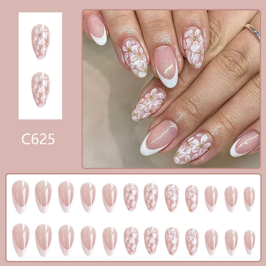 Short almond shaped French style artificial nails with glitter and flower pattern in colour C625