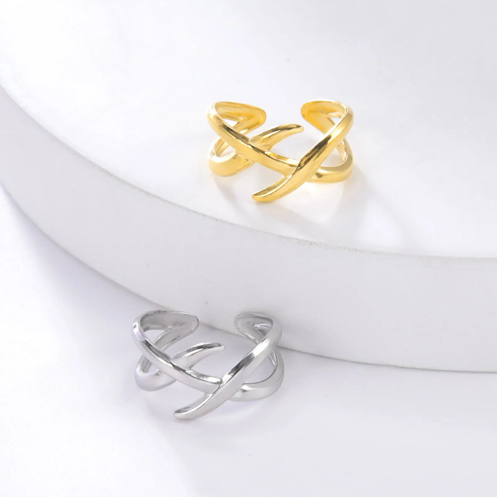 Retro women's stainless steel open ring in gold colour with adjustable opening on white background