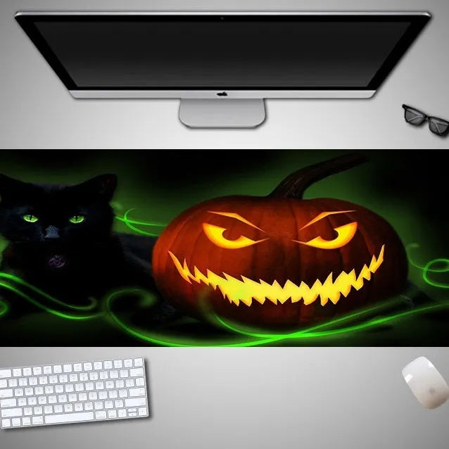 Halloween-themed oversized mouse pad with non-slip rubber cloth backing on a desk