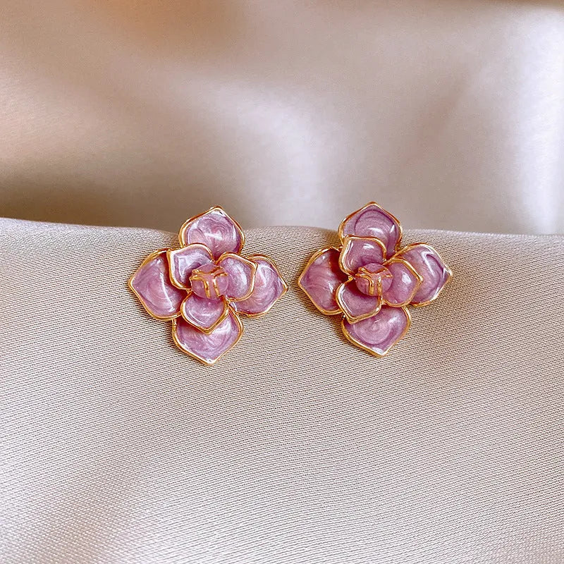 Gold plated purple oil-spot glaze flower stud earrings made from copper on a silver needle post.