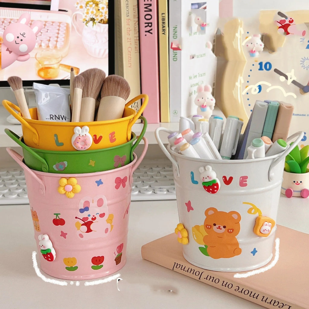 Round metal pen holder with creative iron art design in multiple colour options on a desk
