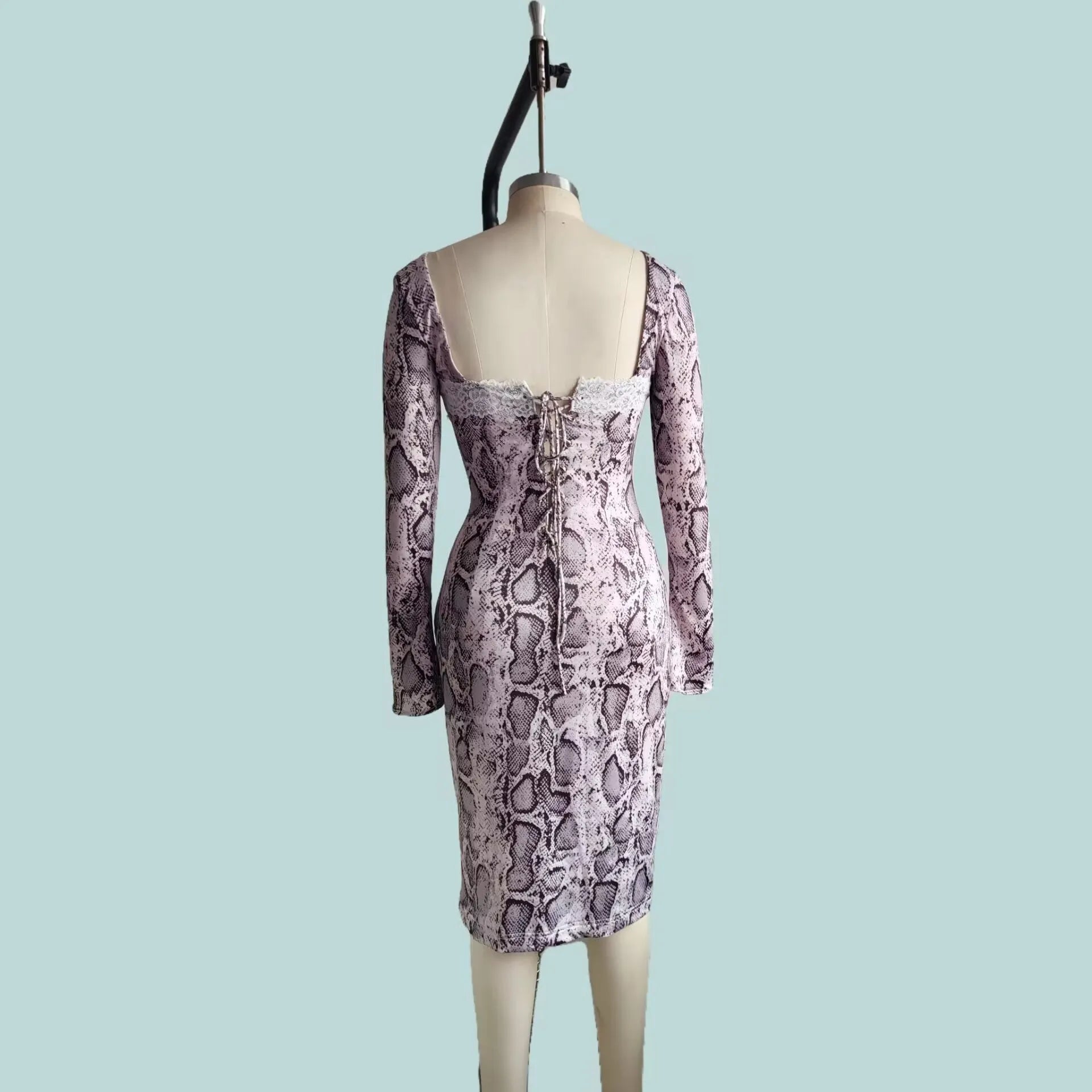 Grey slim fit lace dress with digital printed 3D pattern and long sleeves on a mannequin.