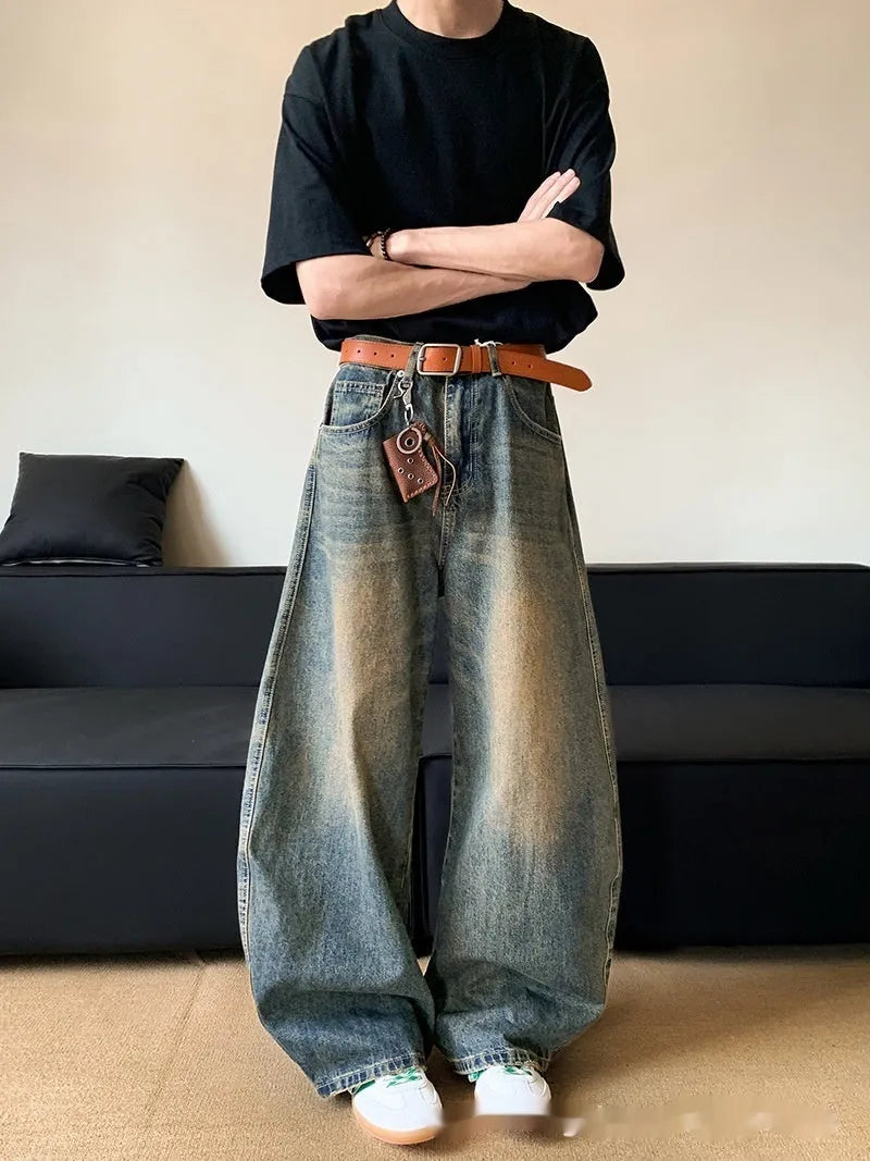Men's retro blue distressed wide-leg jeans with a slimming fit through hips and thighs.