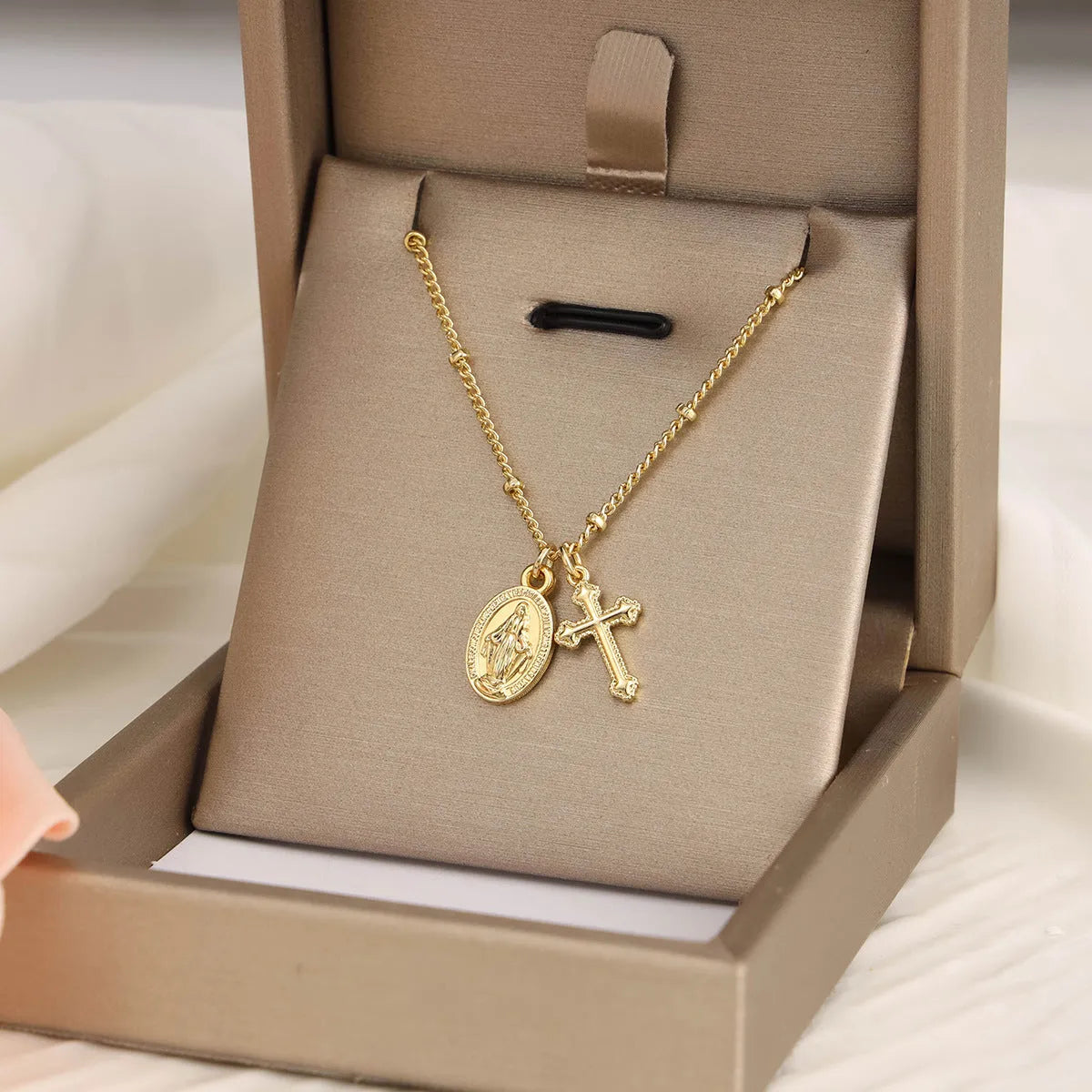 Virgin Mary geometric cross necklace in gold colour with 18k gold-plated copper construction