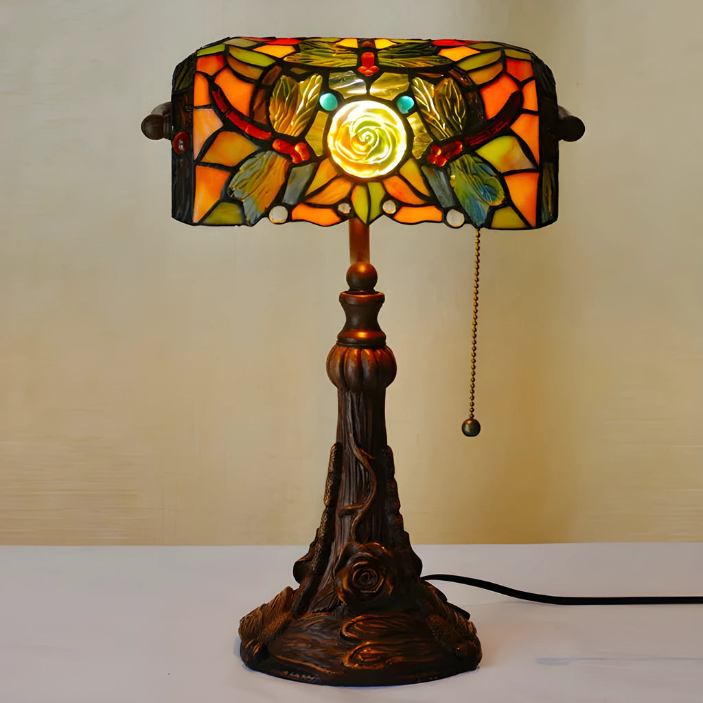 10-inch Tiffany table lamp with coloured glass shade and resin base on a desk.