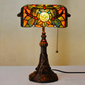 10-inch Tiffany table lamp with coloured glass shade and resin base on a desk.