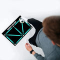 Black rectangular football training mat on grass, measuring 60 by 90 centimetres.