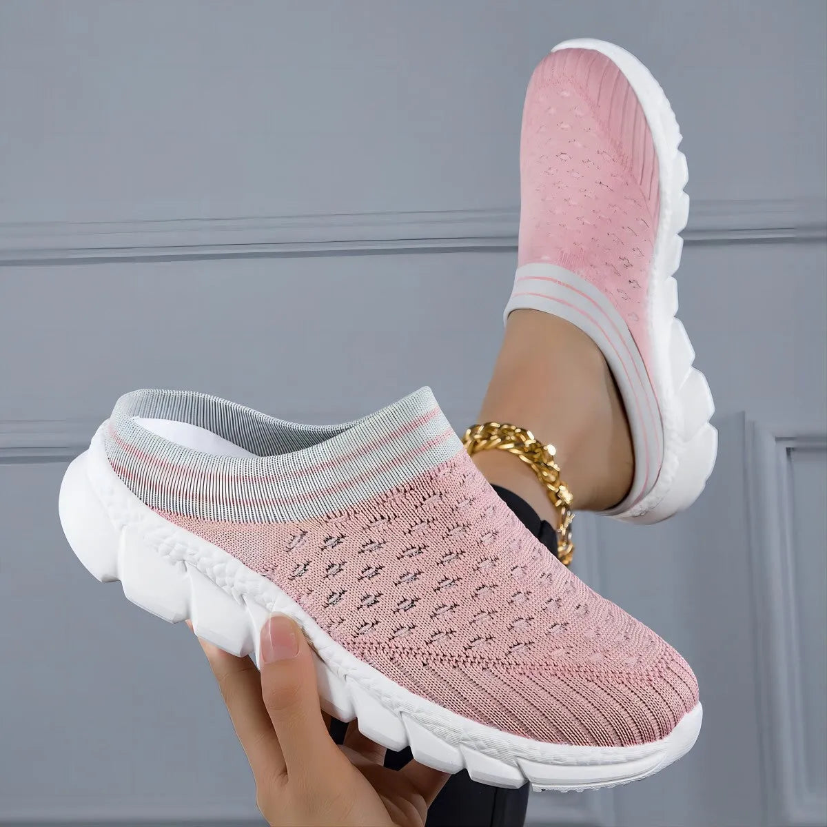 Women's striped Flyknit sports slipper in black with hollowed-out design and height-increasing sole.