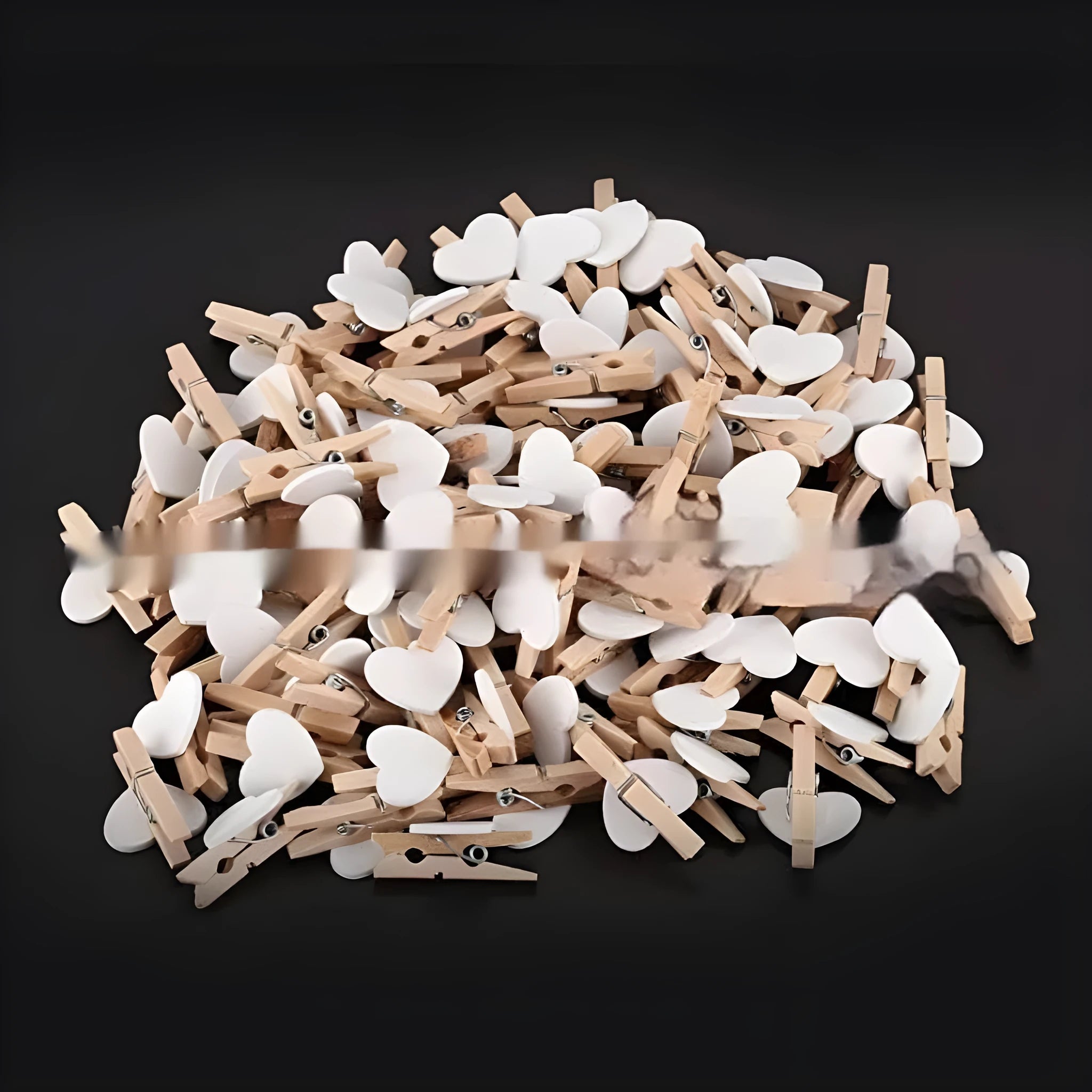 Five handmade solid wood heart-shaped clips in red, pink, white, yellow colours on a wood surface.