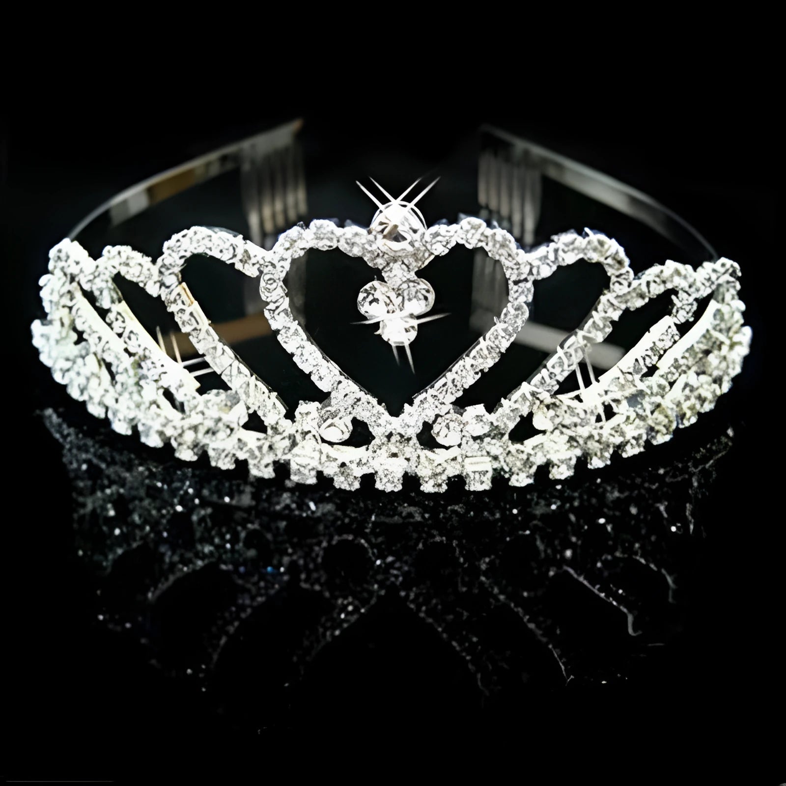 Princess crown hair pin in gold-tone metal with faux gemstones, a bridal hair accessory for wedding hairstyles.