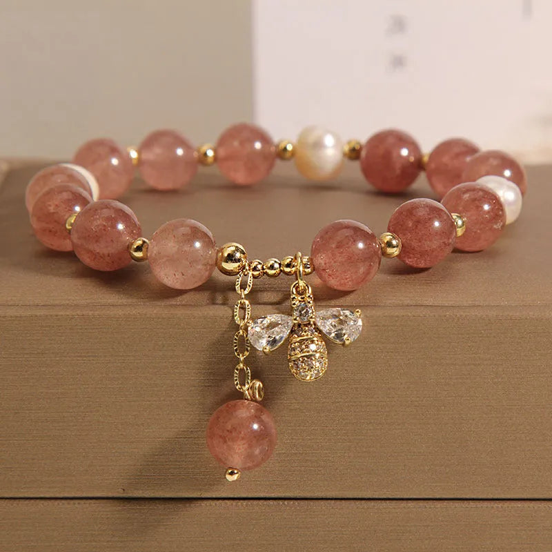 Pink strawberry quartz and white freshwater pearl bracelet with bee charm and zircon accents