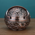 Creative alloy ashtray with smoke extinguishing slot in bronze finish featuring traditional decorative design