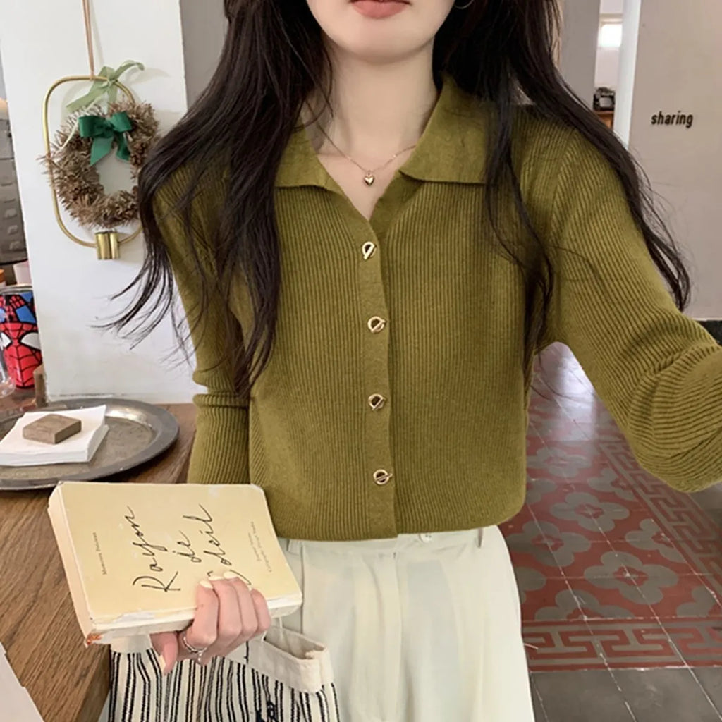 A loose-fitting, long-sleeved beige knitted cardigan for women, made from viscose fibre.