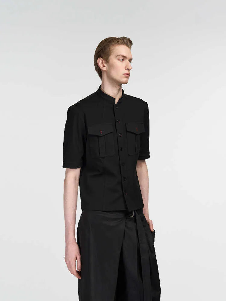 Black handmade half-sleeve hunting shirt with a shirt collar and loose fit on a mannequin.