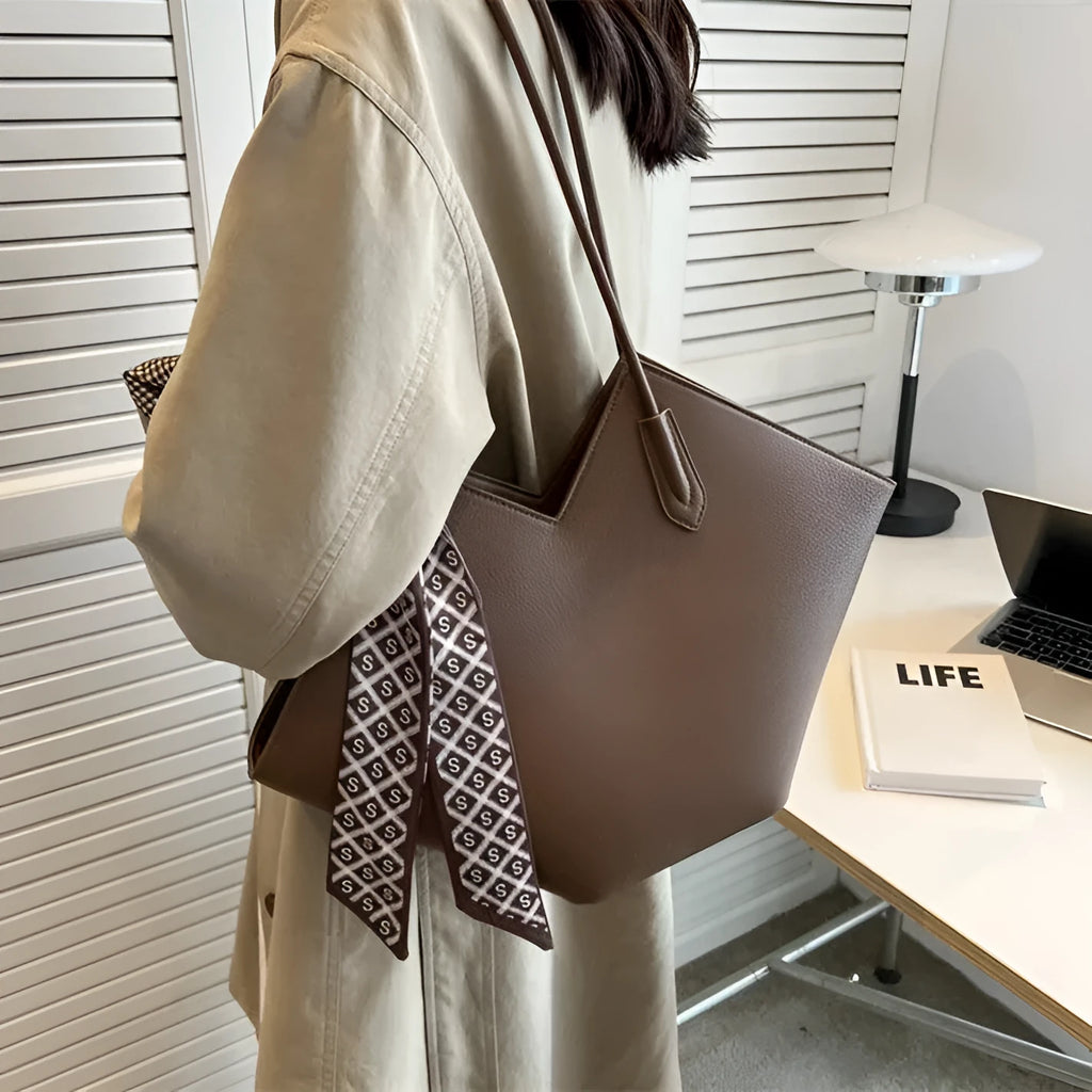 Women's large black PU shoulder bag with an outer pocket, shown in a horizontal square shape.