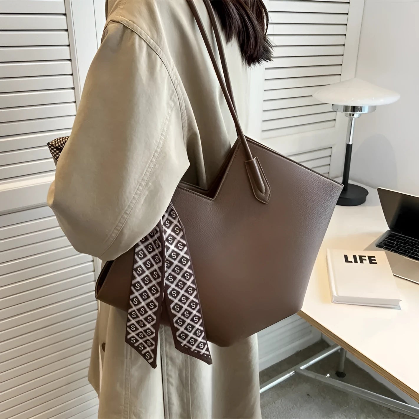 Women's large black PU shoulder bag with an outer pocket, shown in a horizontal square shape.