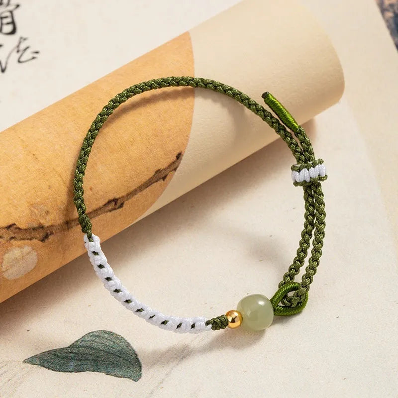 Colourful national fashion bracelet with Hetian jade and sterling silver carrying strap on a neutral background
