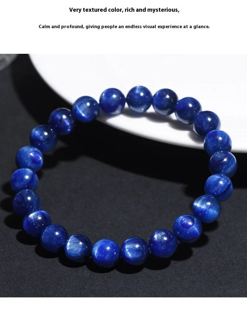 Polished blue crystal bracelet with geometric shapes and ruyi design elements on wrist
