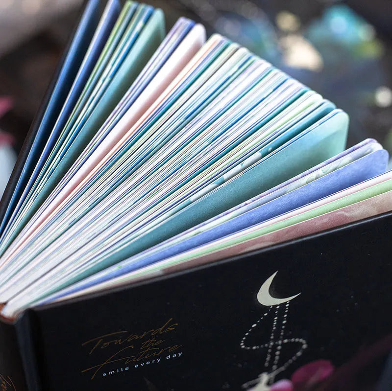 A5 notebook with luminous cover open to show pages with colour illustrations