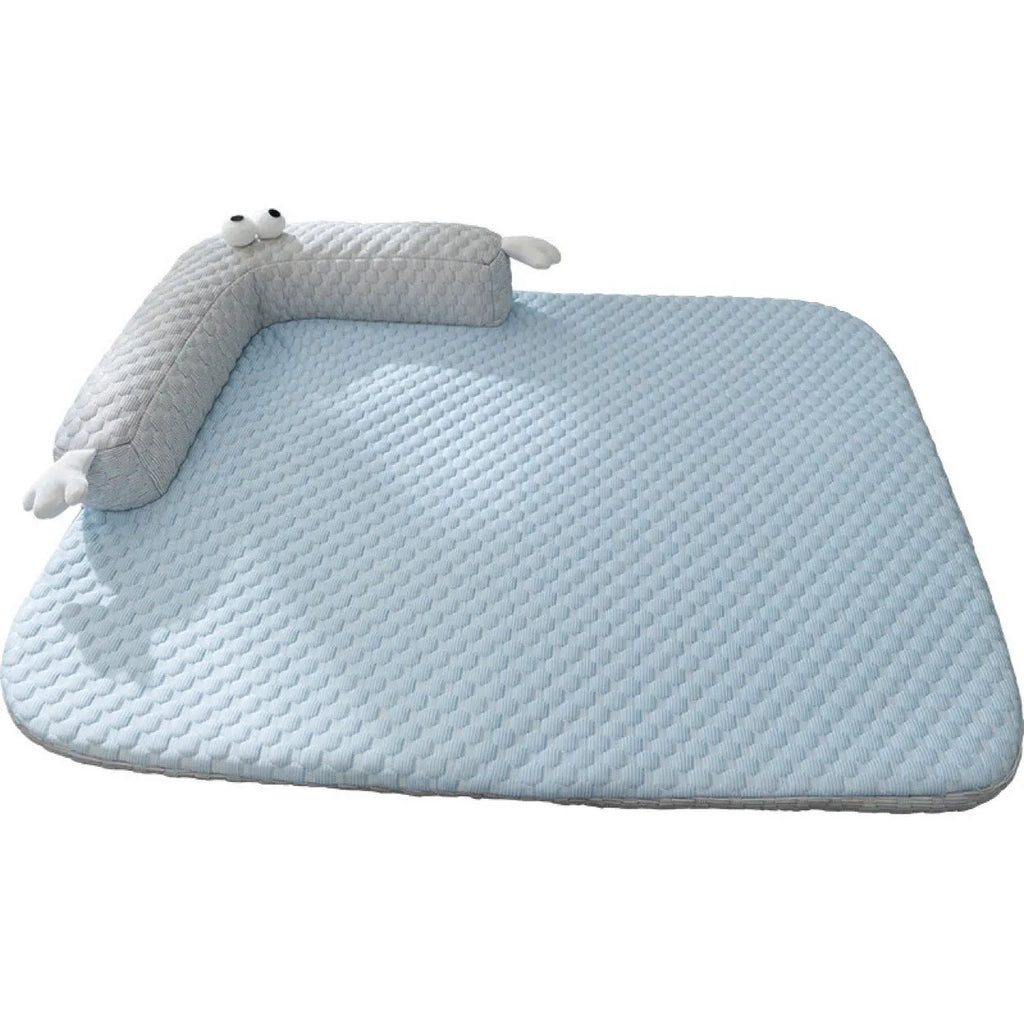 Blue big-eyed monster design breathable pet cooling bed for dogs and cats on a wooden floor.