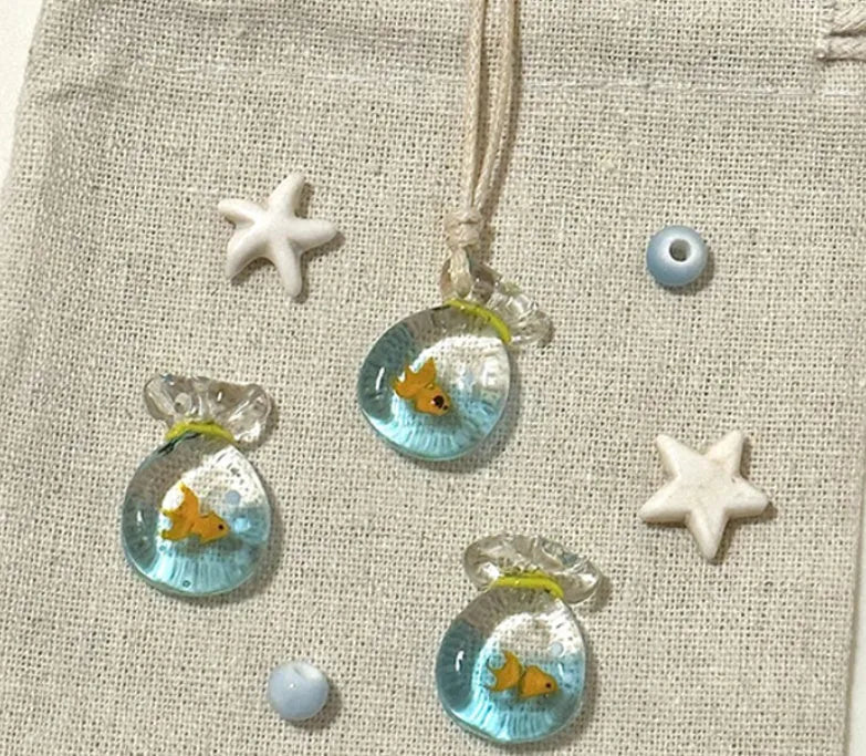 Women's joker charm pendant necklace in coloured glaze on a cotton and linen clavicle chain.