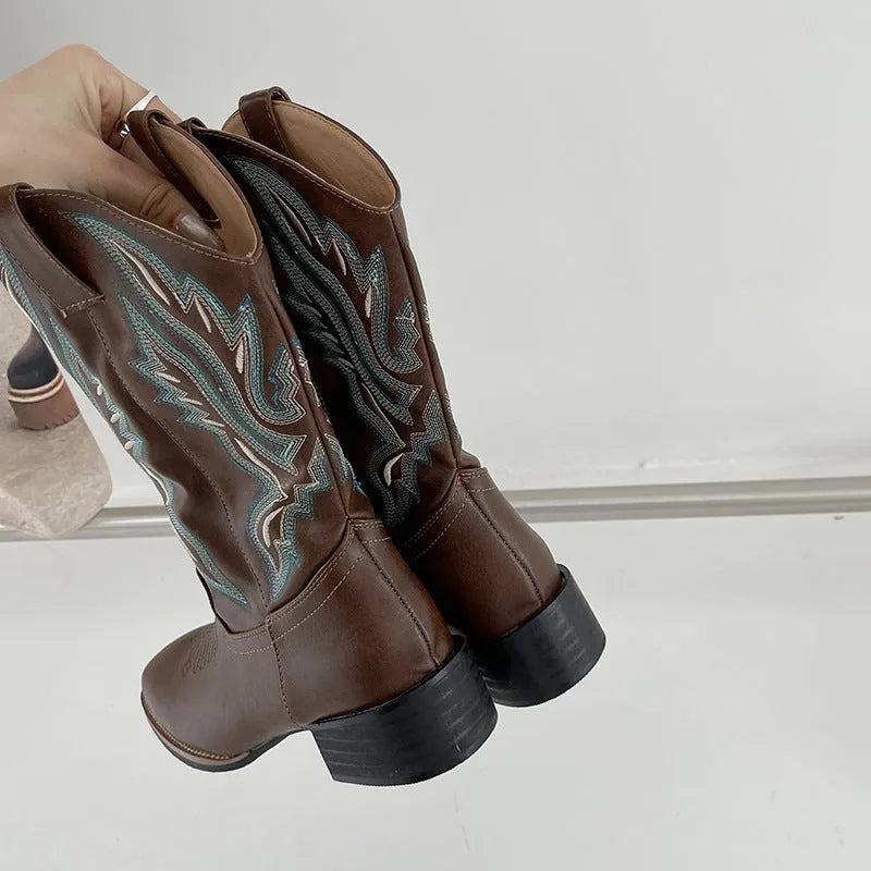 Brown women's mid-calf Martin boots with embroidered pattern, leather lining, and a lace-up front.