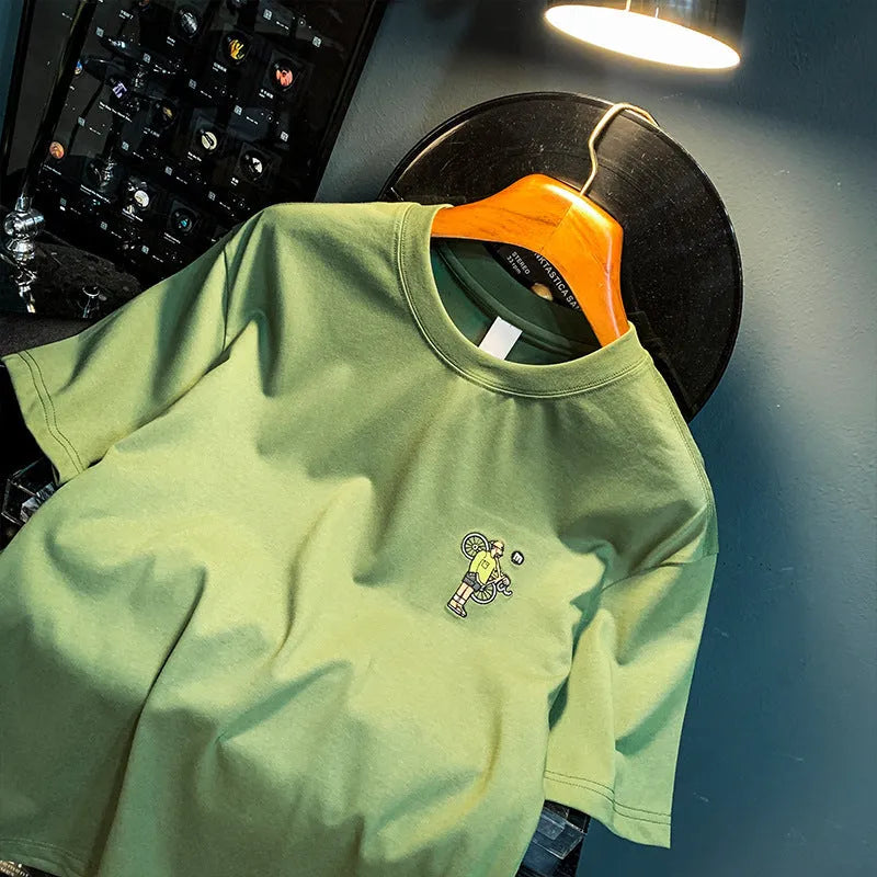 Green men's loose fit T-shirt with a Literary Youth graphic print on the front.