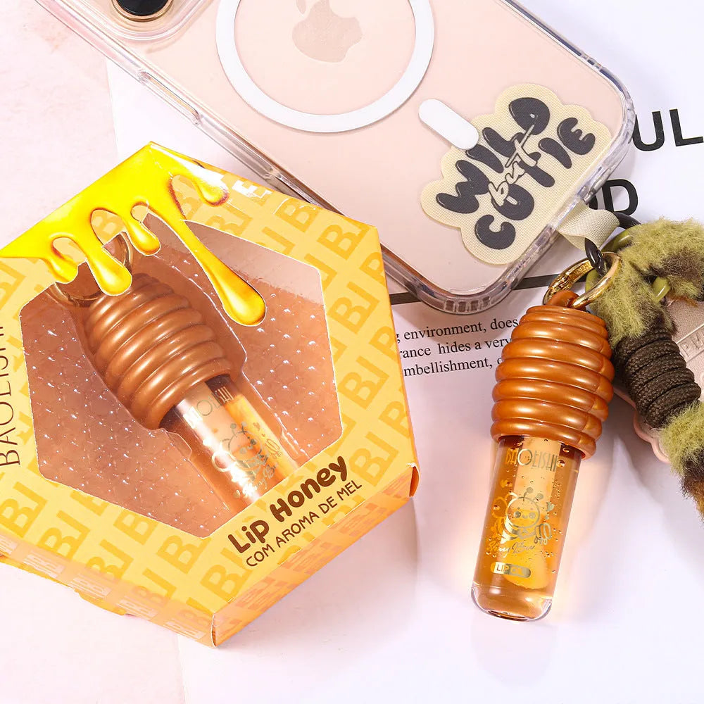 Honey Lip Gloss with keychain attached, showing portable design for bags and paniers