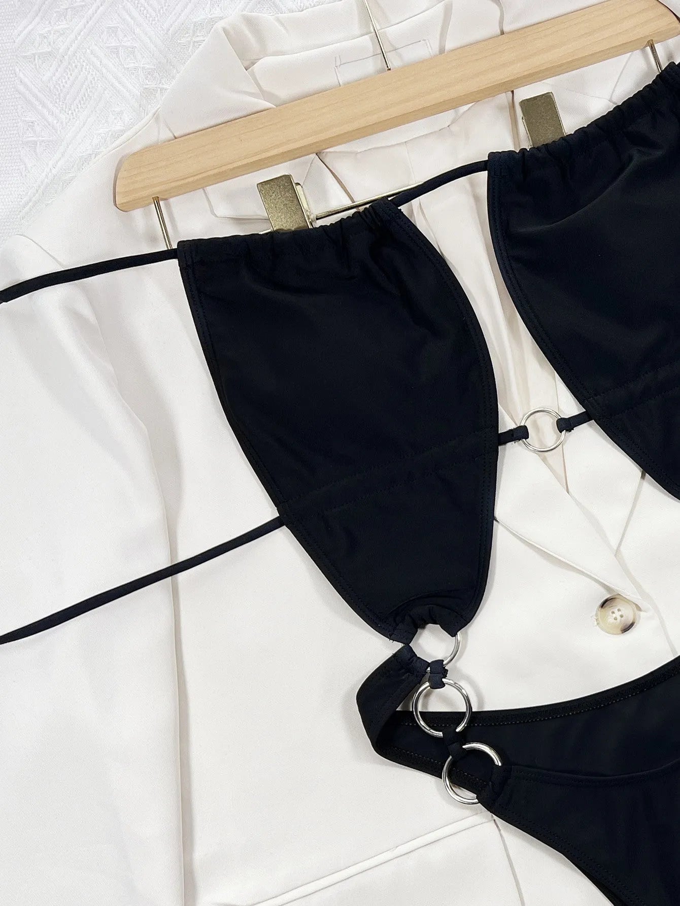 A solid black women's sleeveless one-piece swimming suit on a mannequin.