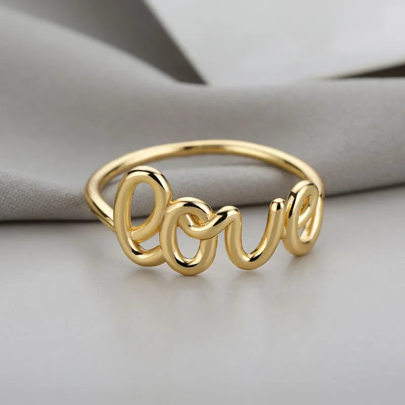 Small unisex copper LOVE ring with engraved text in gold finish for couples