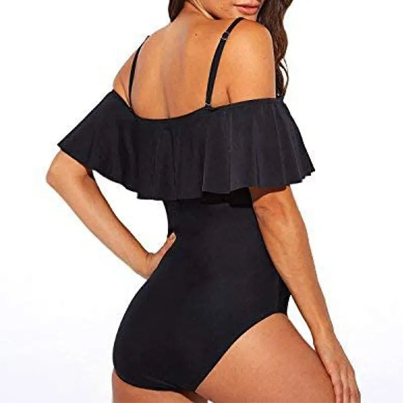 Black one-piece swimsuit with cut-out ruffled straps on a tube top