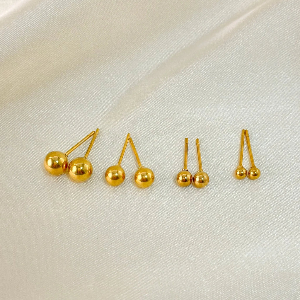 Stainless steel ball stud earrings in gold and silver finishes, showing 3mm, 4mm, 5mm and 6mm size comparison.