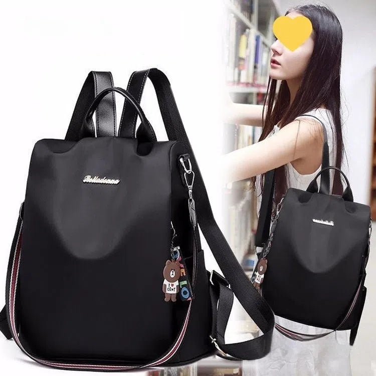 Women's large capacity black backpack with Oxford fabric lining, laptop sleeve, and trendy stitched seams and colour blocking