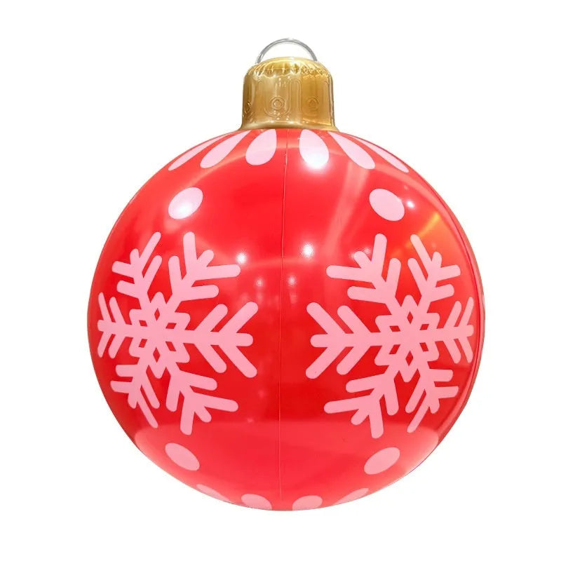 Large red and white inflatable Christmas ball with flashing lights displayed in outdoor garden setting