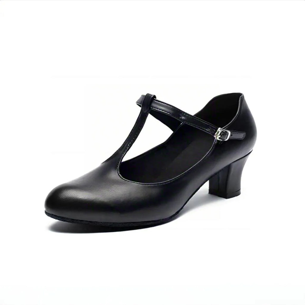 Women's black leather Latin dance shoes with T-shaped straps on a wooden dance floor