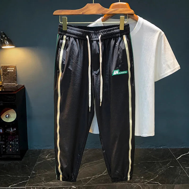 Men's black harem style trousers with mid-waist design and cotton blend fabric