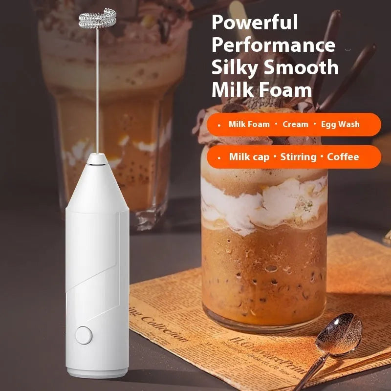 Mini handheld electric milk frother in black, with stainless steel whisk and USB charging cable.