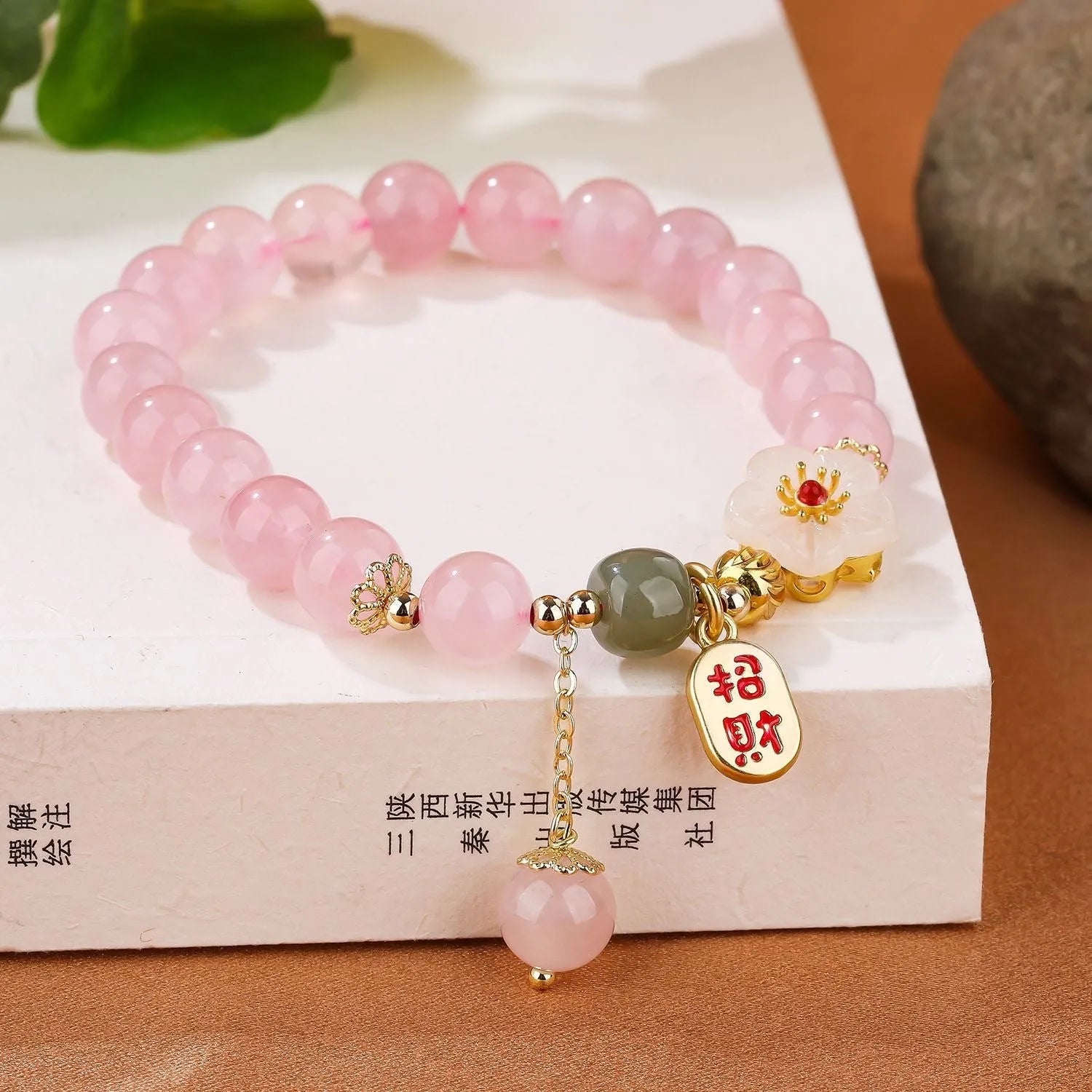 Women's aquamarine crystal bracelet with round geometric beads in mixed materials including natural pink crystal and imitation pearl