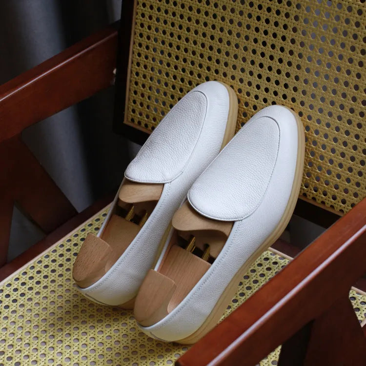 Men's handmade leather loafers in brown with TPR sole on wooden surface