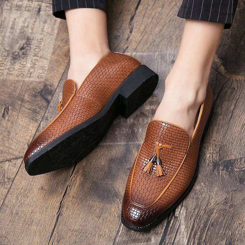 Men's black pointed toe slip on loafers with a tassel detail on the front.